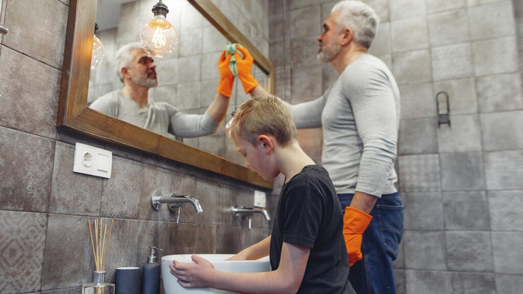 Father & Son cleaning the bathroom together.