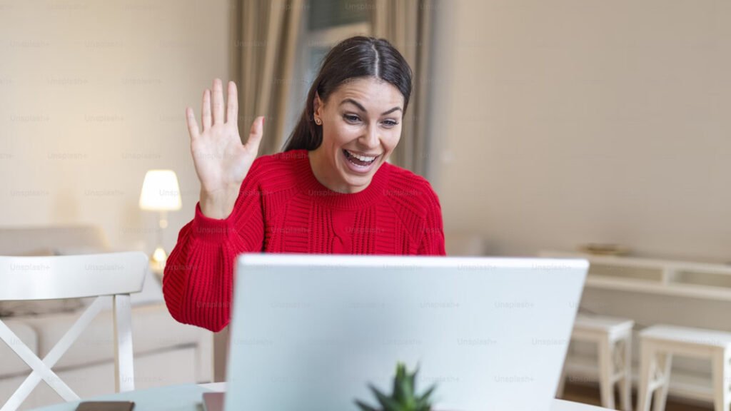 Woman in red sweater on a zoom call